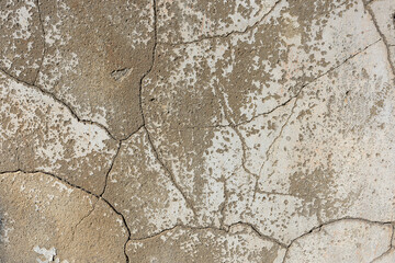 texture of cracked lime mortar wall with traces of paint