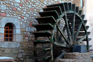 Fototapeta premium ancient wooden wheel water mill in village