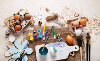 Easter DIY. Easter preparation, multi-colored paints and a brush for decorating eggs. Creativity with children.