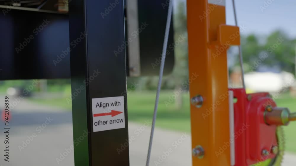 Poster a mobile construction stop light is cranked into position. arrows indicate where the proper alignmen