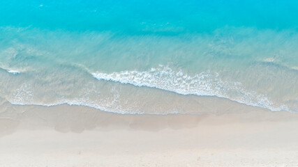 The soft wave water of the sea on the sandy beach background