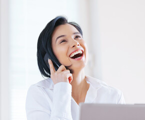 Woman, business and laughing with laptop, phone call and conversation while working as...