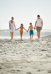 Parents, children and beach on vacation in summer with holding hands and smile for happiness in Florida. Family, adventure and travel for holiday with kids to relax, fun and enjoy trip in seaside.