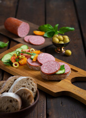Cervelat sausage cut into pieces on a cutting board