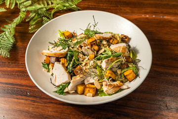 Salad with chicken and nuts. Hotel restaurant meal. Variation of caesar salad.