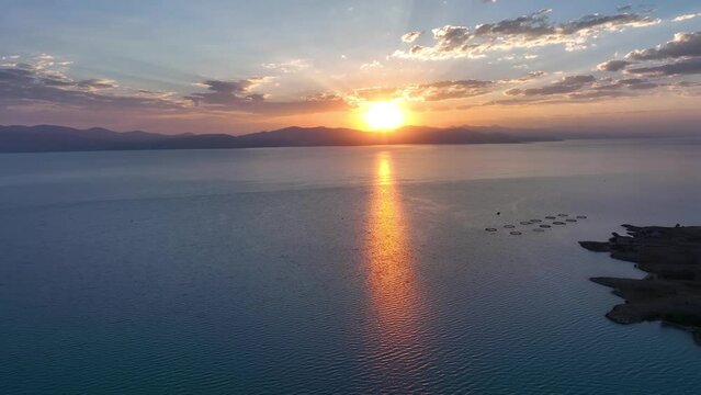 Scenic sunset or sunrise over Sevan lake popular holiday destination in Armenia, Caucasus, West Asia. Daytime of moving white, grey clouds over lake Sevan on background hills