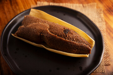 Chocolate Tamale. hispanic dish typical of Mexico and some Latin American countries. Corn dough wrapped in corn leaves. The tamales are steamed. Usually accompanied with atole, hot chocolate or coffee