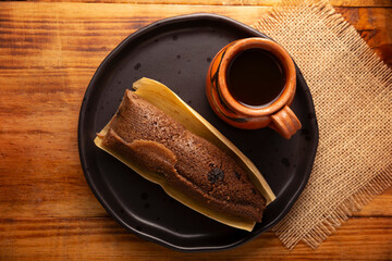 Chocolate Tamale. hispanic dish typical of Mexico and some Latin American countries. Corn dough wrapped in corn leaves. The tamales are steamed. Usually accompanied with atole, hot chocolate or coffee