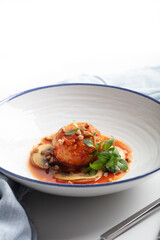 Contemporary gluten-free kitchen: buckwheat and chicken mince patties with mushrooms, tomato sauce, and micro basil greens. Focus on health. Copy space