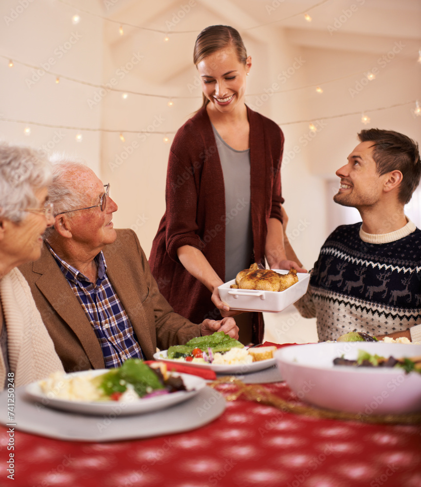 Sticker Christmas, dinner and family smile at table together with food and celebration in home. Senior, mother and father with happiness at lunch with woman hosting holiday with dish of chicken on plate