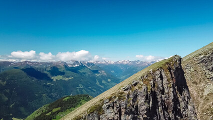 Panoramic view of majestic mountain peaks of Karawanks and Julian Alps seen from Boese Nase in Ankogel Group, Carinthia, Austria. Idyllic hiking trail in remote Austrian Alps in summer. Alpine valley