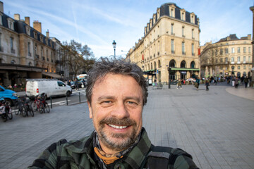 happy handsome man taking selfie with mobile phone tour tourist guy in bordeaux city