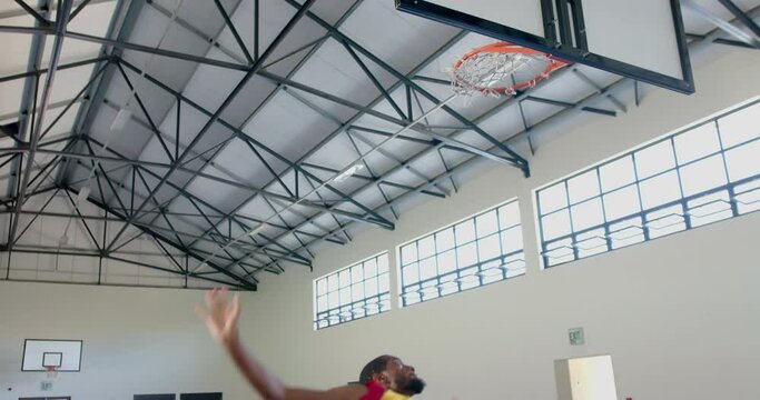 African American man playing basketball indoors, with copy space