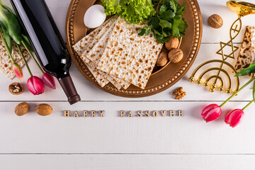 Festive background for the spring holiday of the Jewish Passover. Traditional foods, flowers, minor...