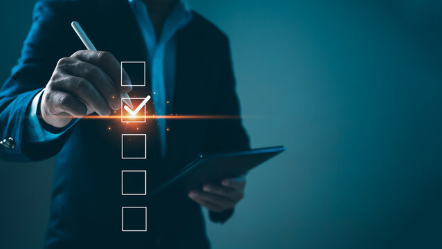 Checklist and filling survey form online. Document management system, DMS. Quality control and accuracy Check, Businessman using tablet online survey filling out, Business performance monitoring.