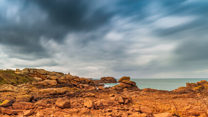 Fototapeta na wymiar Panoramic view of the pink granite coast in Brittany. You can see the lighthouse of Ploumanac'h