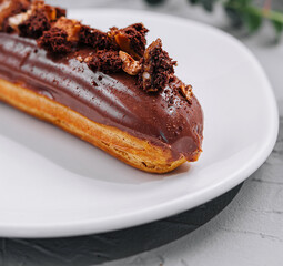Eclair with Chocolate Cream and Hazelnuts closeup