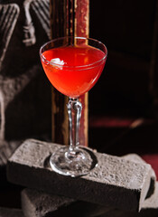 Italian cocktail with flower on gray stone
