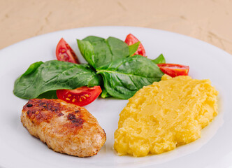 polenta with cutlet and cherry tomatoes with basil