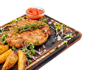 Grilled steak with baked potatoes on wood