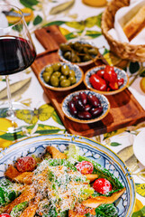 Fresh healthy caesar salad and red wine