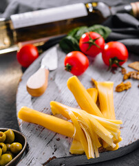 Smoked braided cheese on wooden board