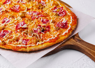 Pepperoni pizza with sausage on wood background