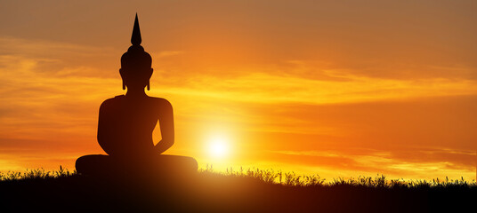 Silhouette of Buddha mediating in the twilight with sunrise background. Magha Puja, Asanha Puja, and Visakha Puja Day. Buddhist holiday Concept.