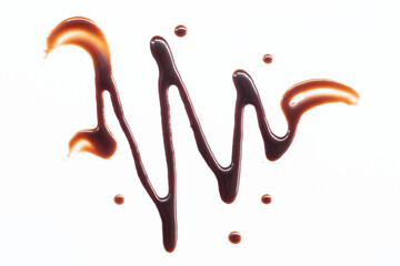Chocolate syrup drizzle isolated on white background. Splashes of sweet chocolate sauce. Top view.