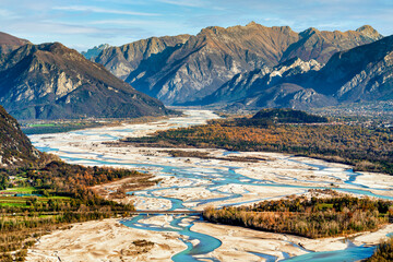 Aerial view of Tagliamento river with Carnia Julian alps in background. Beautiful Italian...