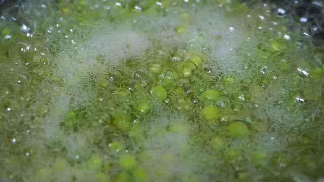 Boil green peas in hot water