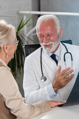 Fototapeta premium A specialist doctor consults with an elderly female patient in his office
