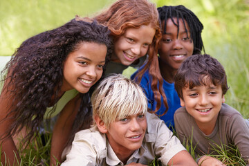 Friends, smile and group of children in field together for summer camp, adventure or outdoor fun....