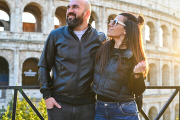 Happy  Beautiful Tourists  couple traveling at Rome, Italy, in front   of Colosseum at  Rome.taking...