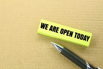 pen and paper with the word wecl are open today. open shop concept today