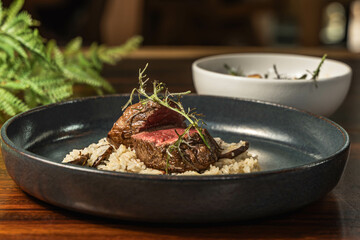 Delicious cut of meat in medium rare with an exquisite rice base. Delicious hotel restaurant food. Main course.