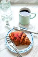 Delicious freshly baked raspberry croissant and a mug of black coffee - 741293058