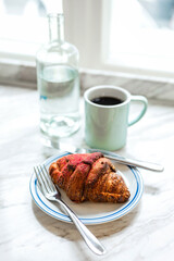 Delicious freshly baked raspberry croissant and a mug of black coffee - 741293824