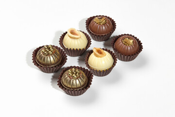 Assorted designer exquisite chocolate candies on white background