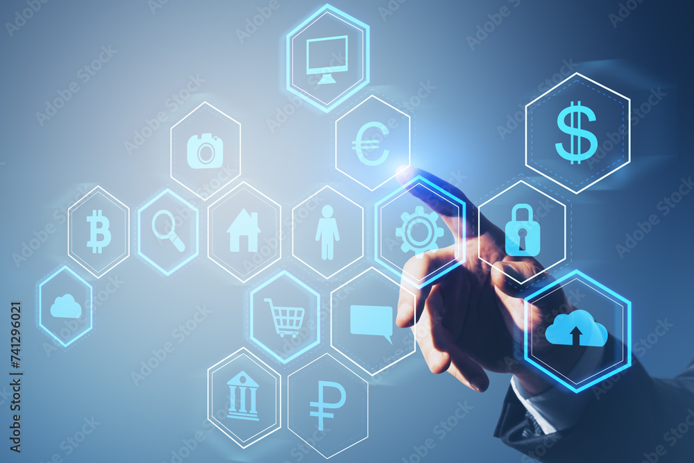 Poster Close up of male hand pointing at abstract hexagonal pattern hologram with various business icons on light blue background. Digital dashboard and data concept.