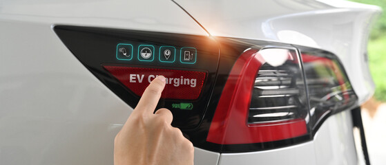 Close up image of man opening a socket cap to preparing to charge an electric vehicle