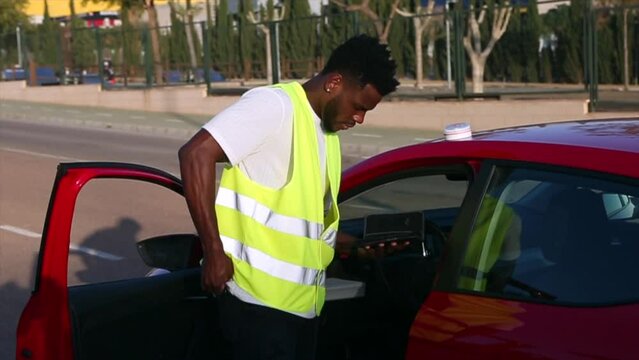 A man wearing a reflective vest calls 911 after his vehicle breaks down.