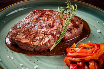 tasty steak with grilled pepper