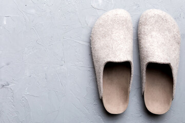 Warm winter women woolen slippers on the floor. Copy space for text