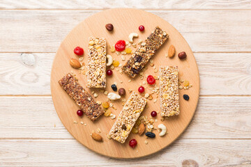 Various granola bars on table background. Cereal granola bars. Superfood breakfast bars with oats, nuts and berries, close up. Superfood concept