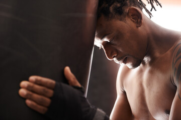 Boxing, fatigue and black man with punching bag in gym for challenge, fight and competition...