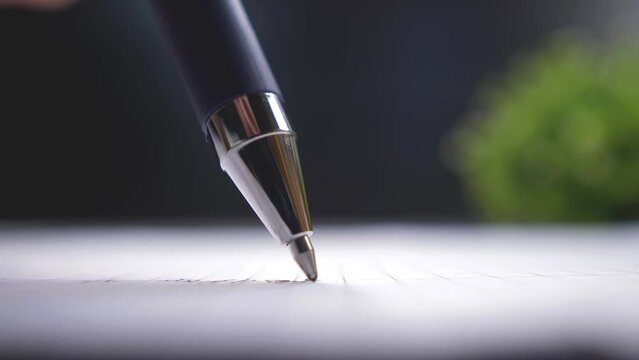 Ballpoint pen. Gel ink pen writes on a white sheet, macro view