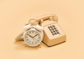 Vintage composition. Telephone and alarm clock. Old style.