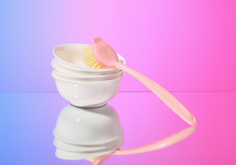 A brush and clean empty plates. Household and home hygiene routine.