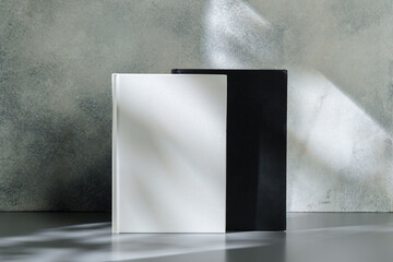 Black and white hardcover notepads on gray background